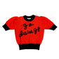 A bright red knit sweater with black trim, featuring puff sleeves, a black crew neck, and 'go daws' written across the chest in black knit lettering.