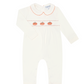 A long-sleeve baby playsuit in ivory with embroidered orange and red details on the chest, shown as a product overlay on a dark gray Shopify product page background.